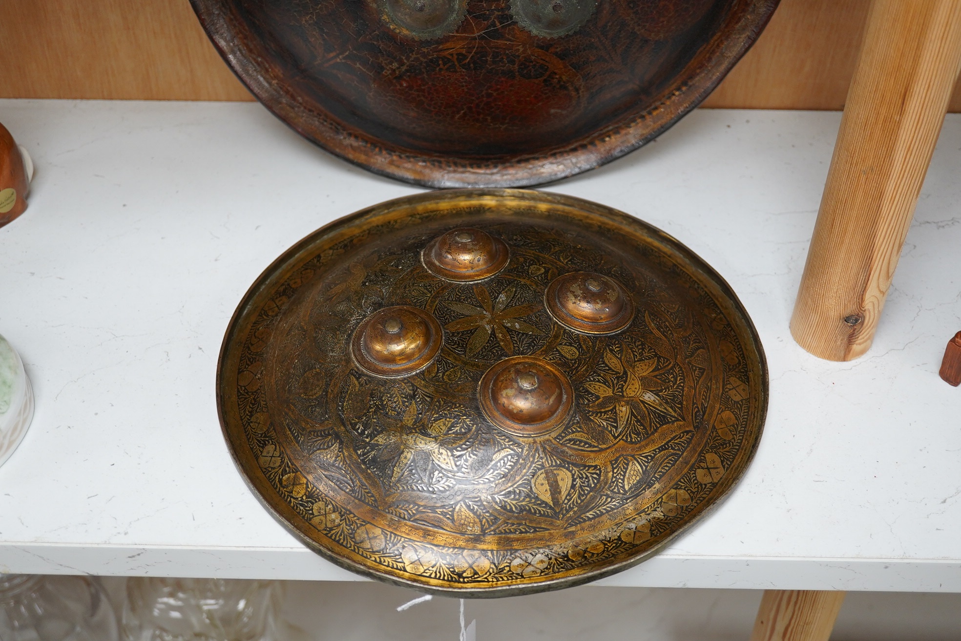 Two Persian style shields, one papier mache the other metal, largest 34cm diameter. Condition - good